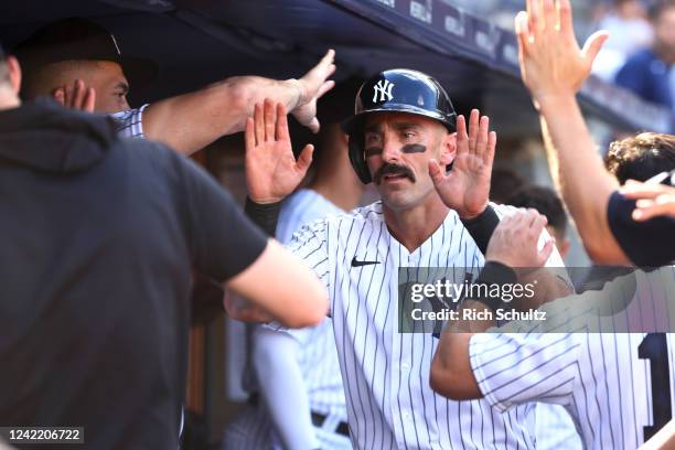 Matt Carpenter of the New York Yankees is congratulated after he hit a home run against the Kansas City Royals during the seventh inning of a game at...