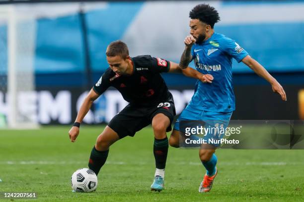 Claudinho of Zenit St. Petersburg and Daniil Kulikov of Lokomotiv Moscow vie for the ball during the Russian Premier League match between FC Zenit...