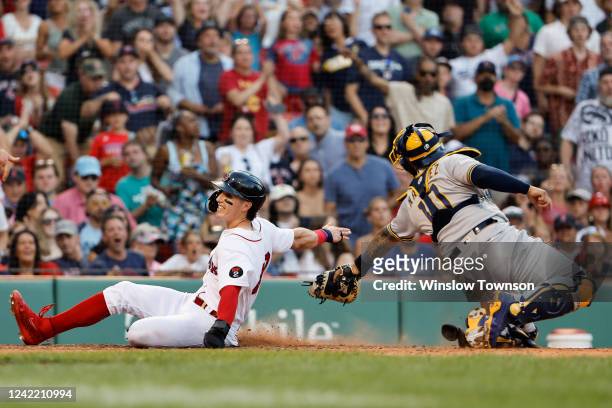 Jarren Duran of the Boston Red Sox scores scores past the tag of catcher Omar Narvaez of the Milwaukee Brewers during the seventh inning at Fenway...