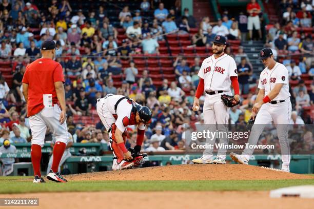 Manager Alex Cora of the Boston Red Sox heads out to take pitcher Ryan Brasier out of the game during the ninth inning against the Milwaukee Brewers...