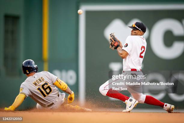 Xander Bogaerts of the Boston Red Sox misses a catch as Kolten Wong of the Milwaukee Brewers doubles during the ninth inning of a game on July 30,...