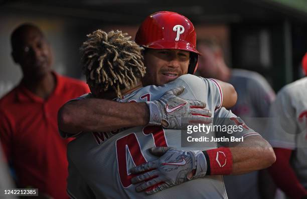 Realmuto of the Philadelphia Phillies hugs Yairo Munoz in the dugout after hitting a solo home run in the sixth inning during the game against the...