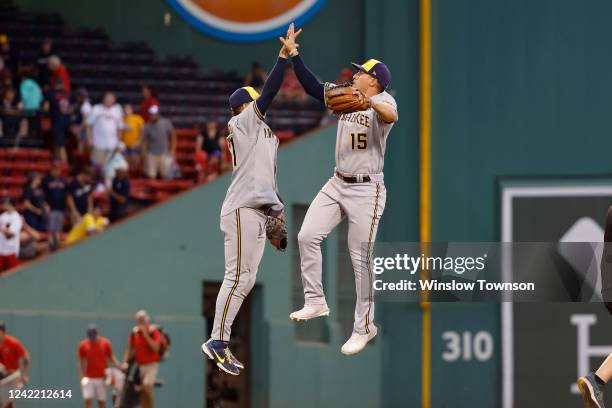 Tyrone Taylor of the Milwaukee Brewers high fives Willy Adames after their 9-4 win over the Boston Red Sox at Fenway Park on July 30, 2022 in Boston,...