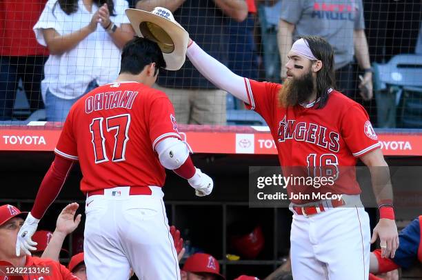 Brandon Marsh of the Los Angeles Angels puts a cowboy hat on the head of Shohei Ohtani of the Los Angeles Angels after he hit a three-run home run in...