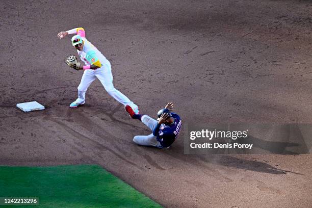 Manny Machado of the San Diego Padres throws over Byron Buxton of the Minnesota Twins as he turns a double play during the sixth inning of a baseball...