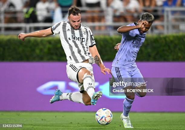 Juventus' Italian defender Frederico Gatti and Real Madrid's Brazilian forward Rodrygo vie for the ball during the international friendly football...