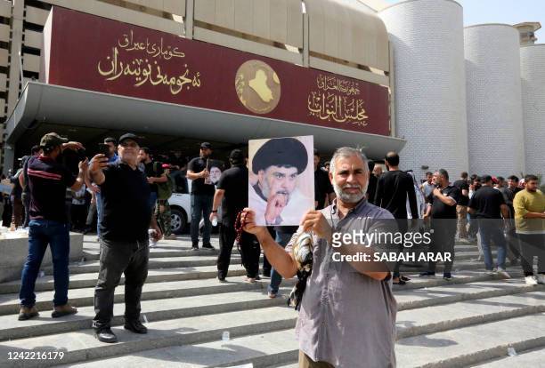 Supporters of Iraqi cleric Moqtada Sadr , protesting against a rival bloc's nomination for prime minister, gather outside Iraq's parliament in the...