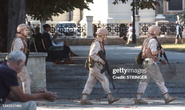 Russian Navy members patrol in front of a headquarter of Russia's Black Sea Fleet in Sevastopol, in Crimea on July 31, 2022. - Ukraine on July 31,...