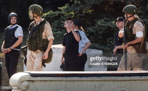 Russian Navy and police members patrol in front of a headquarter of Russia's Black Sea Fleet in Sevastopol, in Crimea on July 31, 2022. - Ukraine on...