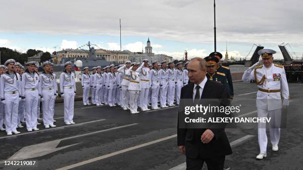 Russia's President Vladimir Putin reviews naval troops as he takes part in the main naval parade marking the Russian Navy Day, in St. Petersburg on...