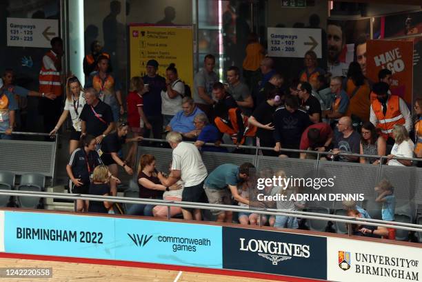 Spectators react to a massive crash during the men's 15km scratch race qualifying round cycling event on day three of the Commonwealth Games, at the...