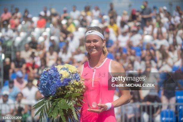 Czech Republic's Marie Bouzkova poses with the trophy after winning the Women's Single Final match against Russia's Anastasia Potapova at the Prague...