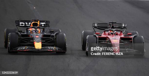 Red Bull Racing's Dutch driver Max Verstappen and Ferrari's Monegasque driver Charles Leclerc compete during the Formula One Hungarian Grand Prix at...