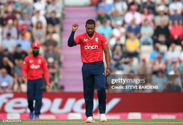 England's Chris Jordan celebrates after the dismissal of South Africa's Reeza Hendricks during the third T20 international cricket match between...