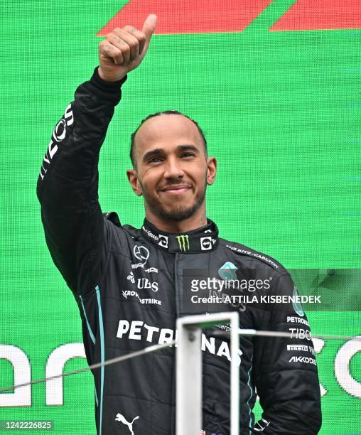 Mercedes' British driver Lewis Hamilton celebrates on the podium after the Formula One Hungarian Grand Prix at the Hungaroring in Mogyorod near...
