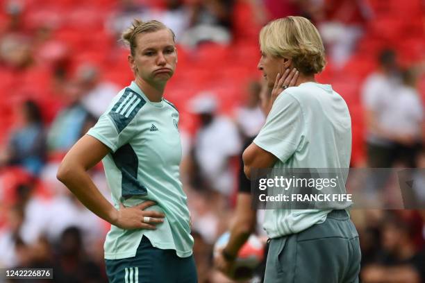 Germany's striker Alexandra Popp reacts as she speaks to Germany's head coach Martina Voss-Tecklenburg prior to the UEFA Women's Euro 2022 final...