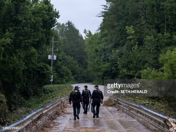 Members of the Lexington Kentucky Fire Department search and rescue team search an area for survivors in Jackson County, Kentucky, on July 31, 2022....