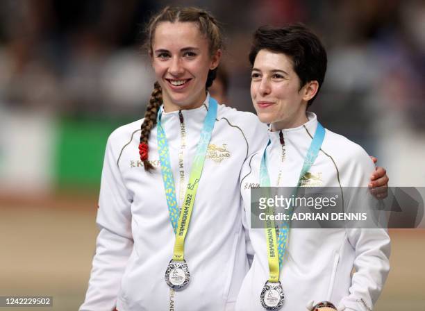 Silver medallists England's Sophie Unwin and pilot Georgia Holt celebrate on the podium during the medal presentation ceremony for the women's...