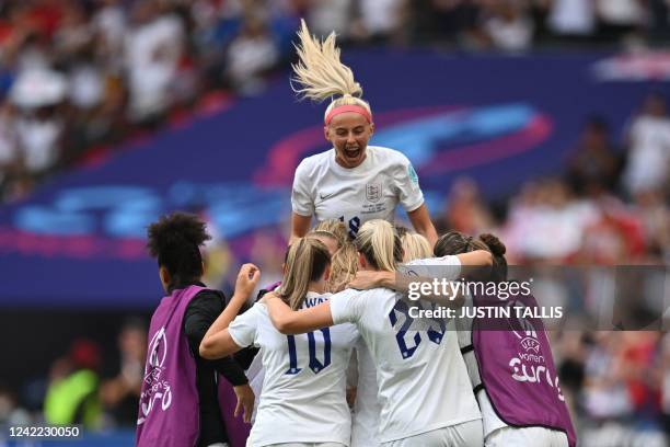 England's midfielder Ella Toone celebrates with teammates after scoring her team first goal during the UEFA Women's Euro 2022 final football match...