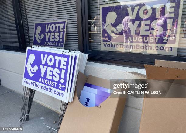 "Vote Yes" signs lean against a building as supporters of Value Them Both, a constitutional amendment that would remove language guaranteeing the...