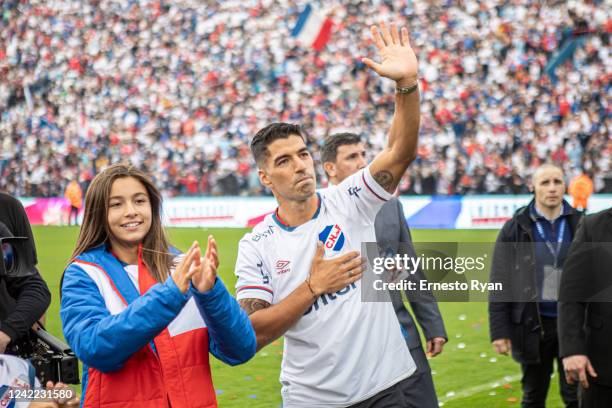 Uruguayan football player Luis Suarez greets fans during his unveiling as the new player of Nacional at the Parque Central Stadium on July 31, 2022...