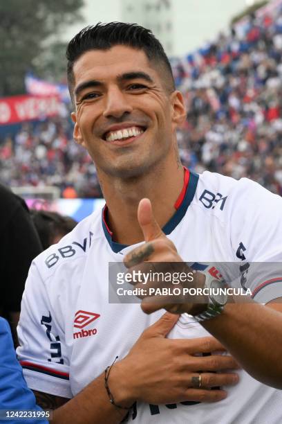 Uruguayan forward Luis Suarez acknowledges the crowd during his presentation as new player of Uruguay's Nacional at the Gran Parque Central stadium,...