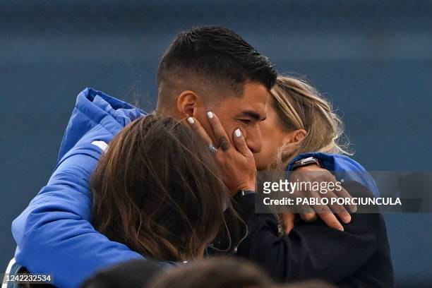 Uruguayan forward Luis Suarez gets emotional next to his daughter Delfina and his wife Sofia Balbi as they watch a video during his presentation as...