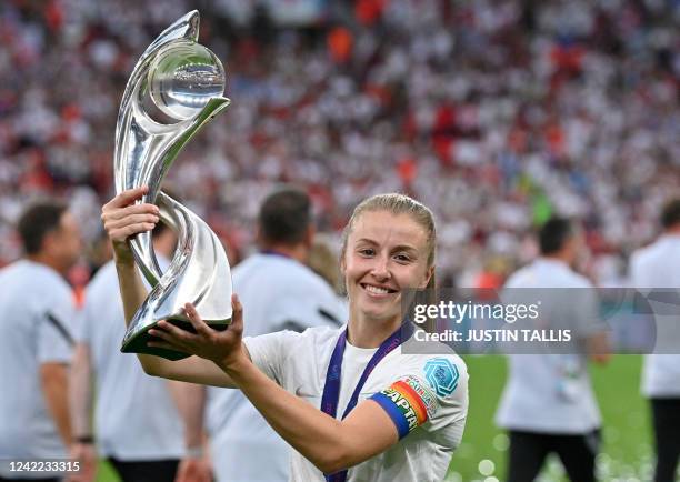 England's midfielder Leah Williamson poses with the trophy as England players celebrate after their win in the UEFA Women's Euro 2022 final football...