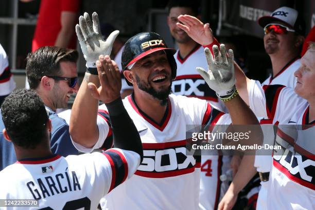 Jose Abreu of the Chicago White Sox celebrates as in the dugout with teammates after hitting a home run against the Oakland Athletics in the second...