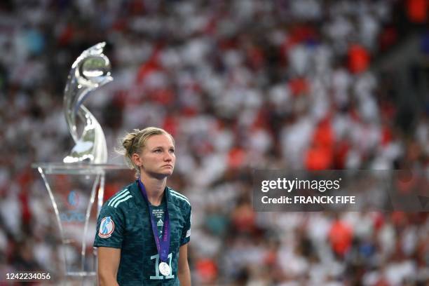 Germany's striker Alexandra Popp walks past the trophy after their defeat in the UEFA Women's Euro 2022 final football match between England and...