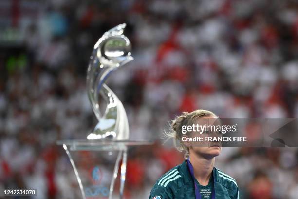 Germany's striker Alexandra Popp walks past the trophy after their defeat in the UEFA Women's Euro 2022 final football match between England and...