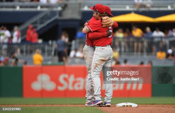 Bryson Stott of the Philadelphia Phillies is hugged by Didi Gregorius after the final out in a 8-2 win over the Pittsburgh Pirates during the game at...