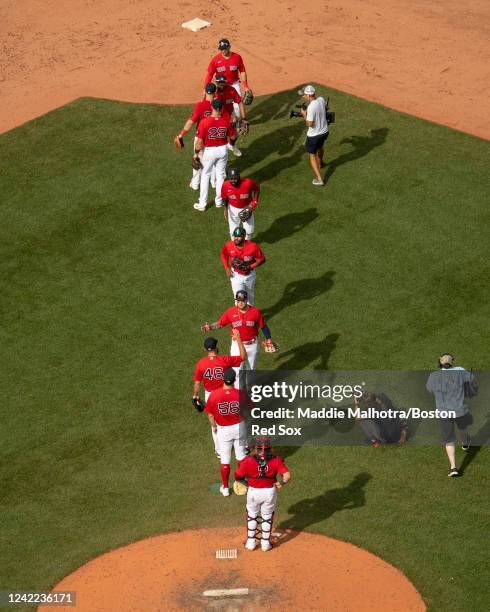 Boston Red Sox players high five after a win against the Milwaukee Brewers on July 31, 2022 at Fenway Park in Boston, Massachusetts.