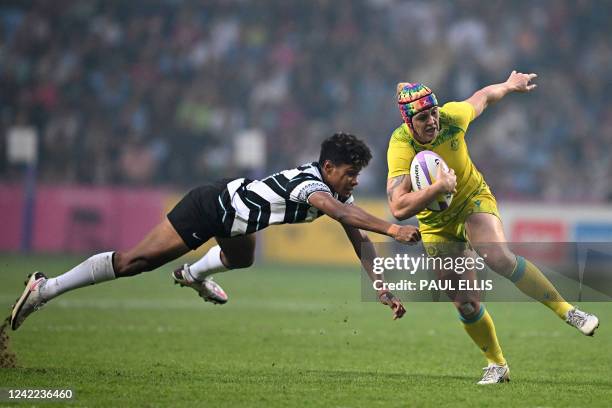 Australia's Sharni Williams is tackled during the women's gold medal rugby sevens match between Australia and Fiji on day three of the Commonwealth...