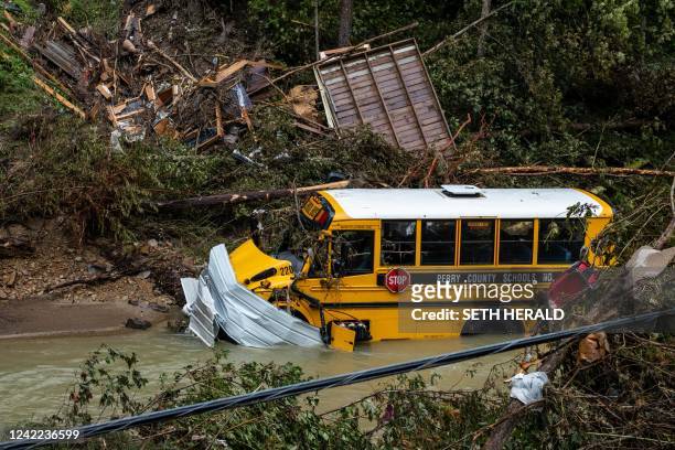 Perry County school bus, along with other debris, sits in a creek near Jackson, Kentucky, on July 31, 2022. - Rescuers in Kentucky are taking the...