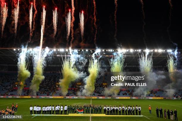 Gold medallists team South Africa celebrate on the podium with silver medallists team Fiji and bronze medallists team New Zealand during the medals...