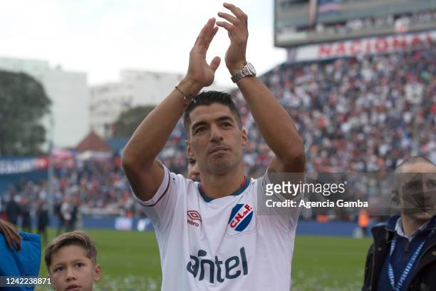 Uruguayan football player Luis Suarez greets fans during his unveiling as the new player of Nacional at the Parque Central Stadium on July 31, 2022...