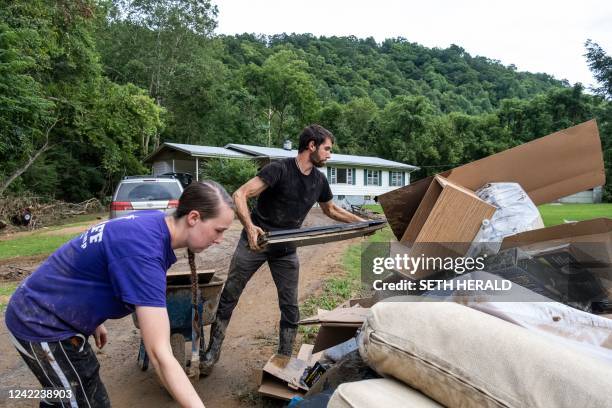 Young couple in Squabble Creek, Kentucky, near Buckhorn, removes items damaged by water from their home following historic flooding in Eastern...