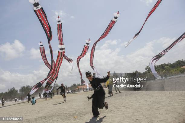 Balinese people fly their Janggan kites during a traditional kite festival in Mertasari Beach, Denpasar, Bali, Indonesia on July 31, 2022. There are...