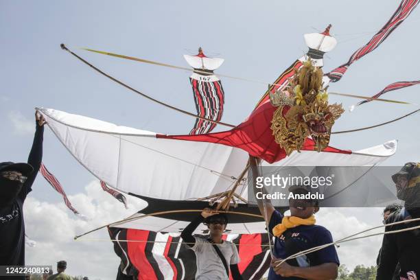 Balinese people fly their Janggan kites during a traditional kite festival in Mertasari Beach, Denpasar, Bali, Indonesia on July 31, 2022. There are...