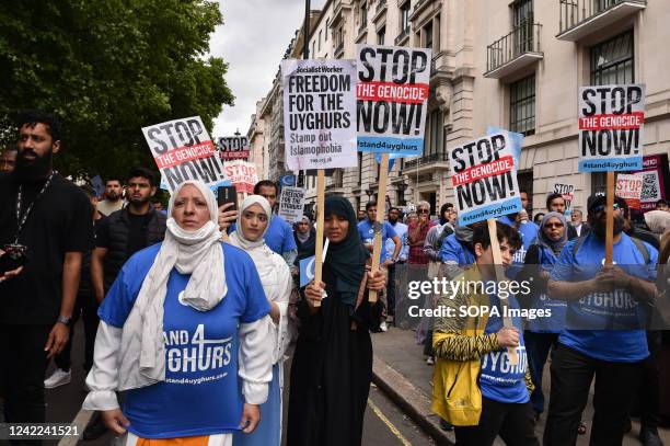 Protesters hold placards expressing their opinion during the demonstration. Uyghurs and UK Muslim organizations gathered opposite the Chinese embassy...