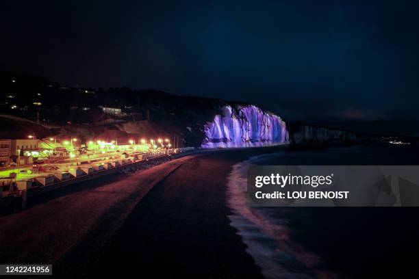 This picture taken on July 31 from the beach in Fecamp, northwestern France, shows an image from "L'Odyssee d'Ho" video mapping during a projection...