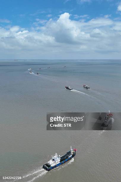 Fishing boats head out to sea on the first day of the fishing season in the Yellow Sea and the East China Sea, in Nantong, in China's eastern Jiangsu...
