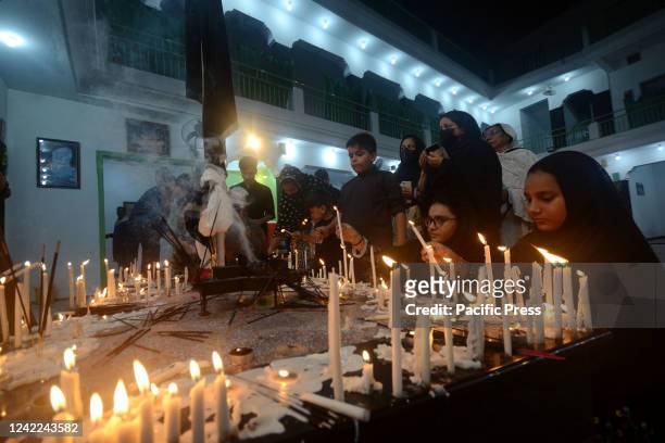Pakistani Shiite Muslims light candles at an Imam Bargah, a Shiite Muslims Mosque, during the holy month of Muharram. Muslims are observing the holy...