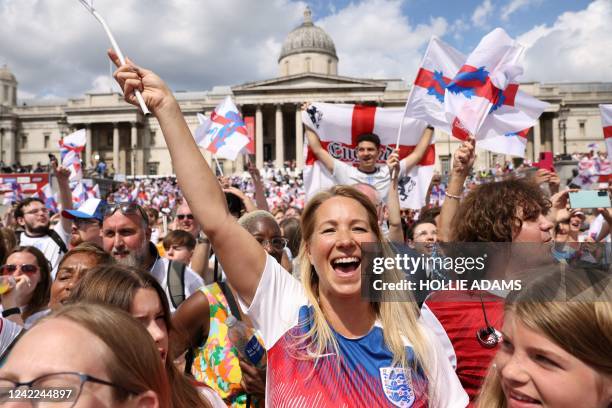 Football fans cheer during a victory party in Trafalgar Square in central London on August 1 a day after England beat Germany 2-1 to win the Women's...