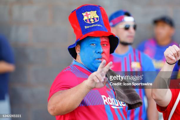 Barcelona fan has a painted face as he awaits the FC Barcelona team arrival outside Red Bull Arena prior to the game between New York Red Bulls and...