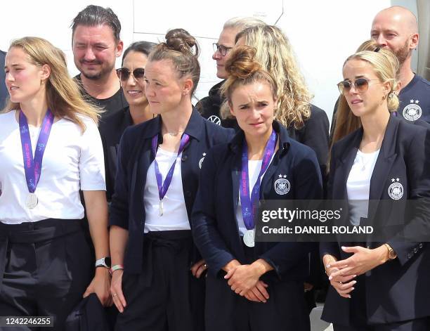 Germany's midfielder Lina Magull , who scored 1-1 goal against England, stands next to Germany's defender Marina Hegering and other players of the...