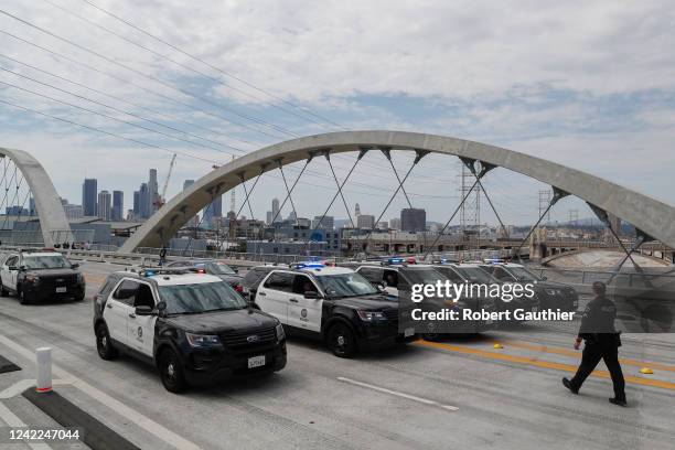 Los Angeles, CA, Sunday, July 31, 2022 - LAPD officers gather to sweep a bike club off the Sixth Street Viaduct while in the midst of a traffic...