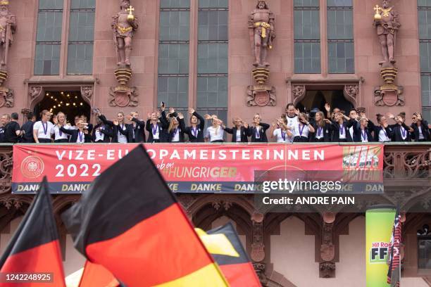 Members of the German national women's football team cheer from the balcony of Frankfurt's city hall "Roemer" as supporters welcome them on August 1,...