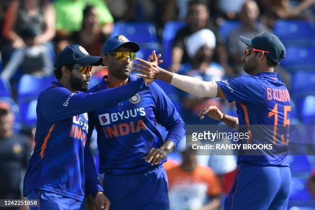 Ravindra Jadeja , Arshdeep Singh , and Bhuvneshwar Kumar , of India, celebrate the dismissal of Nicholas Pooran, of West Indies, during the second...